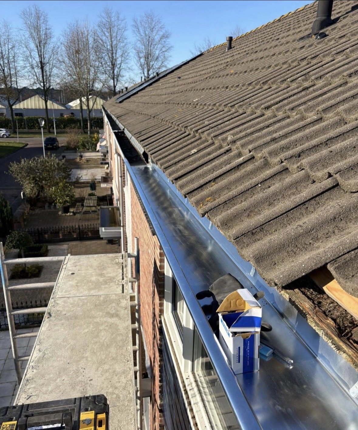 Nieuwe zinken dakgoot langs het dak geplaatst